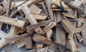 Wooden logs pile high, rough and weathered