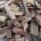 Wooden logs pile high, rough and weathered