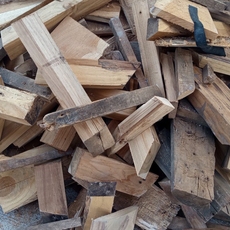 Wooden logs pile high, rough and weathered