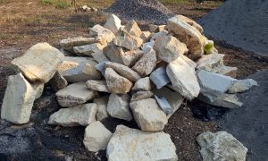 Stacked rocks rest on rough earth